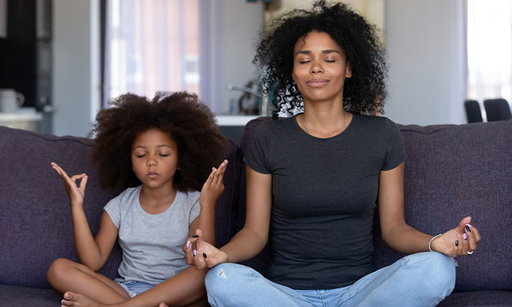 Mother meditating with young child