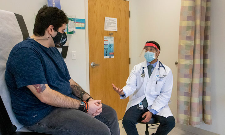 Young man talks to him primary care doctor