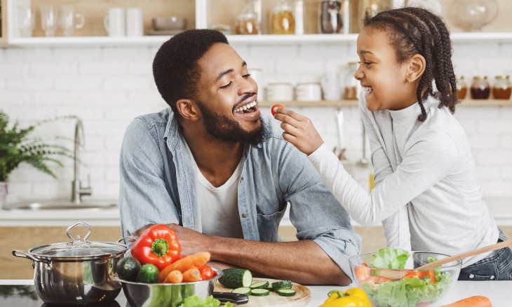 A father and child prepare a healthy meal.