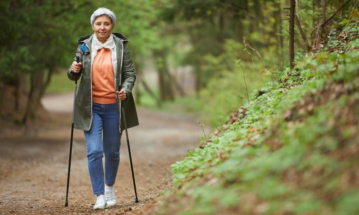 A woman walks along a trail.