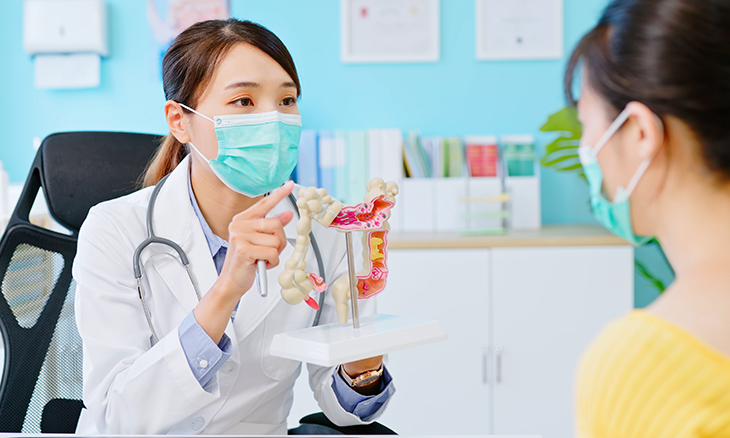 Doctor and patient with colon model
