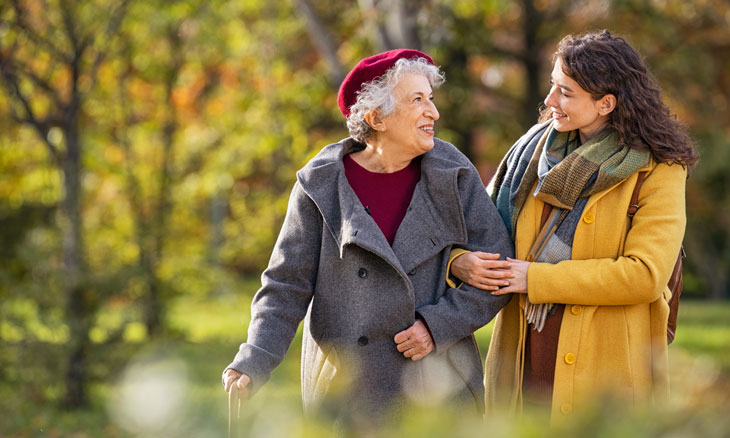 Adult daughter walks with her mother