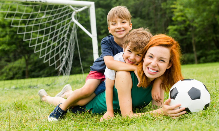 Mom with two boys in grass