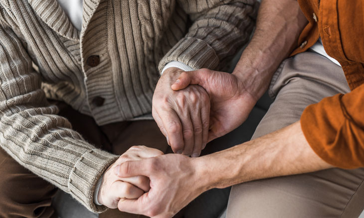Son and father holding hands