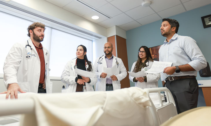 Faculty member discussing a patient's care with family medicine residents