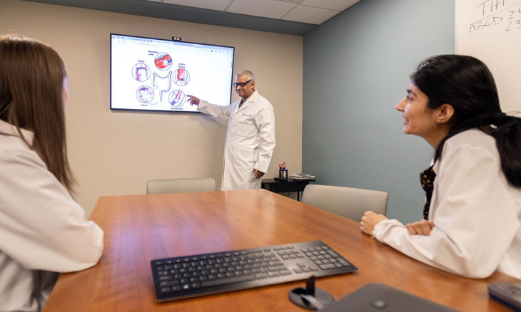 Two gastroenterology residents listening to faculty lecture
