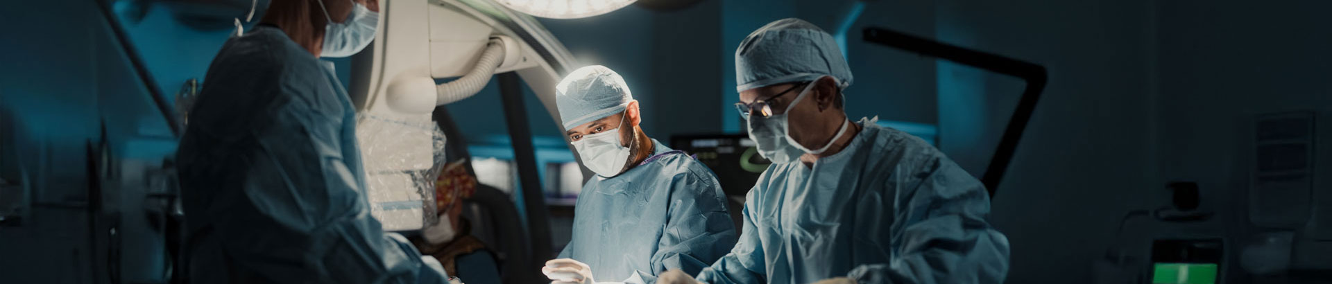 Team of heart specialist conducting surgery in operating room.