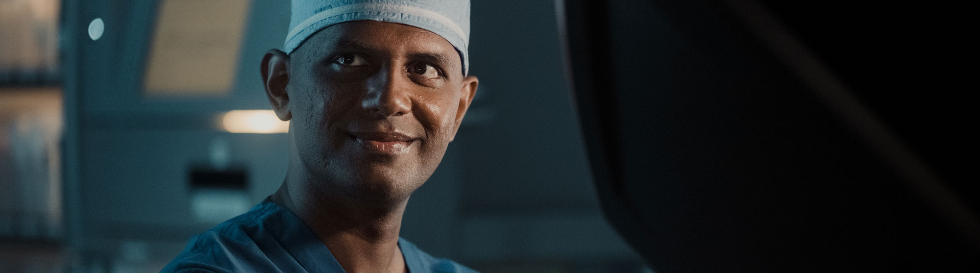 Surgeon smiling at the camera in an operation room