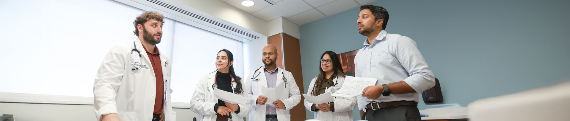 Faculty member discussing a patient's care with family medicine residents