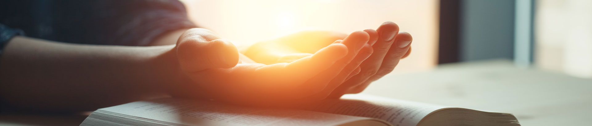 Person placing hand on bible