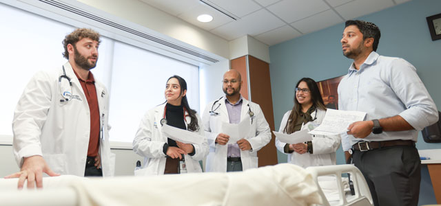 Faculty member discussing a patient's care with family medicine residents