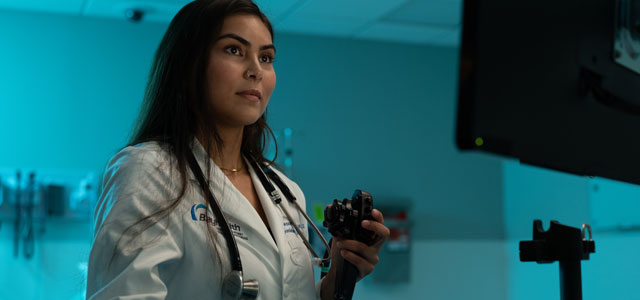 General Surgery resident looking at monitor