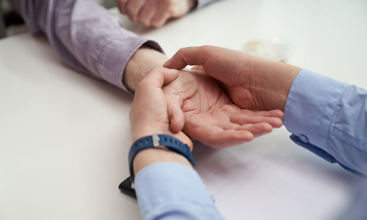Orthopedic surgeon examines hand and wrist